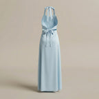 Light blue halter neck dress with a bow detail on a beige background