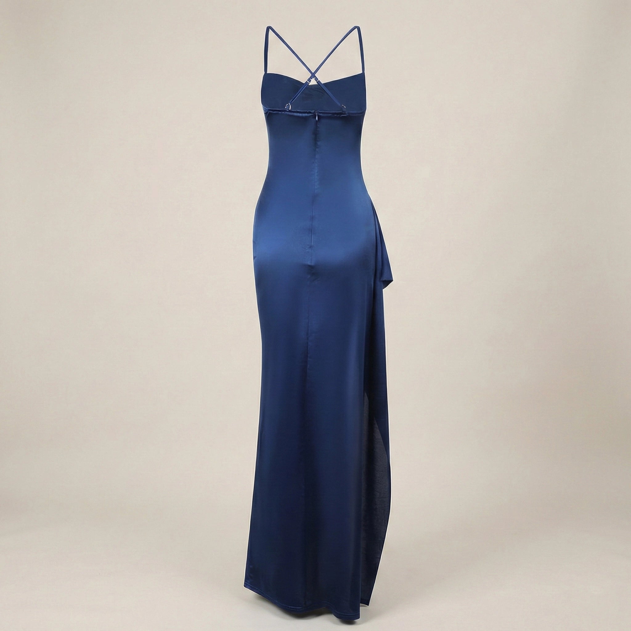 Navy blue evening gown with thin straps on a beige background
