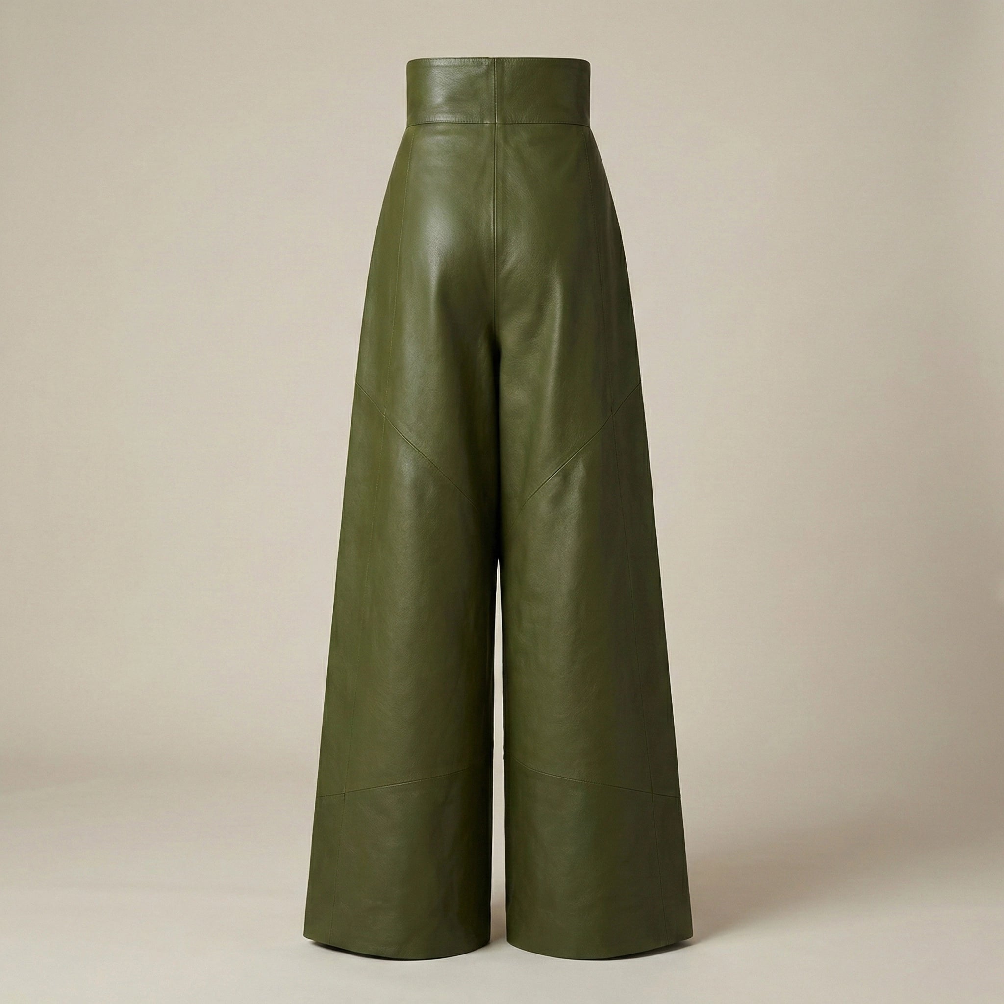 Green leather wide-leg pants on a beige background