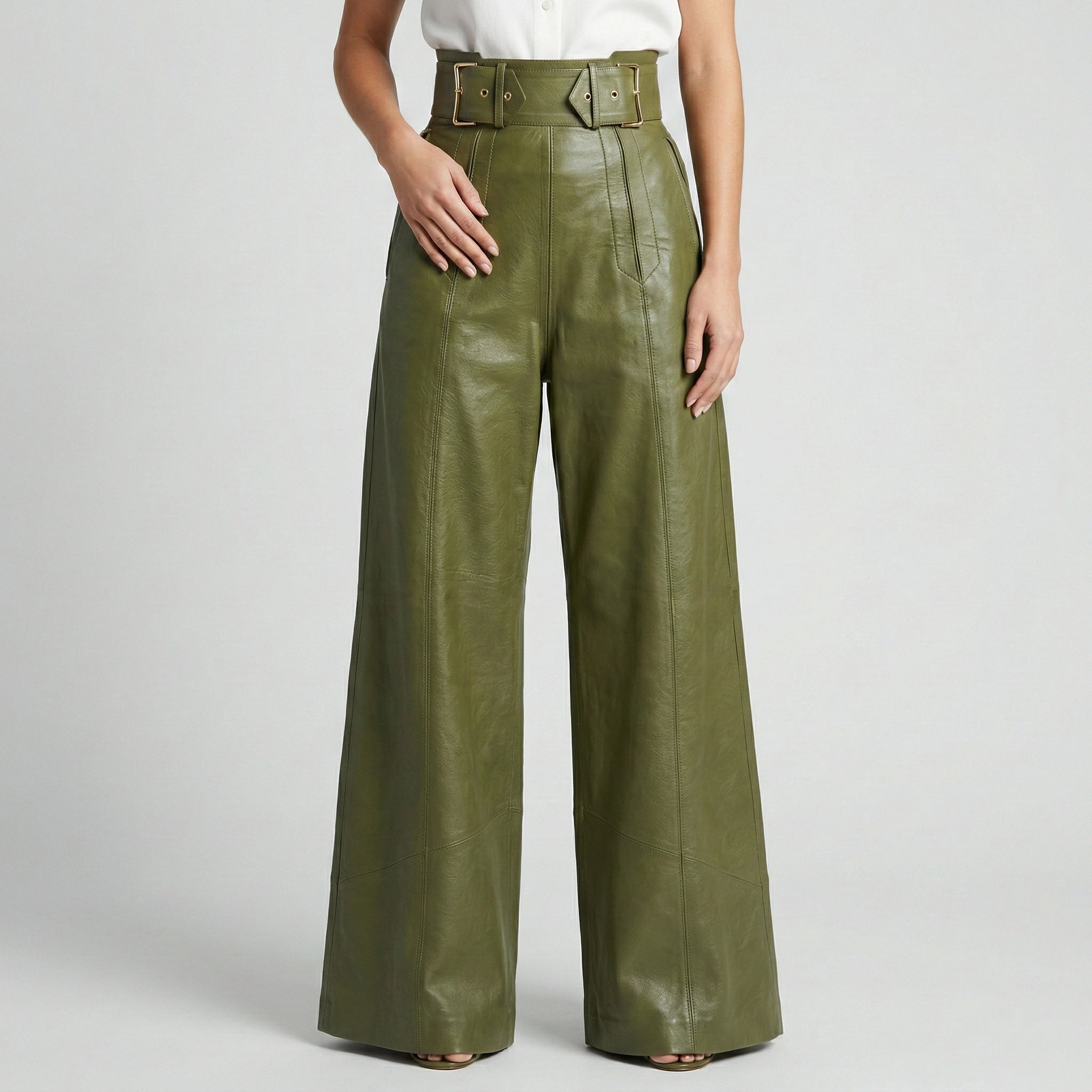 Green leather wide-leg pants worn by a person on a light gray background