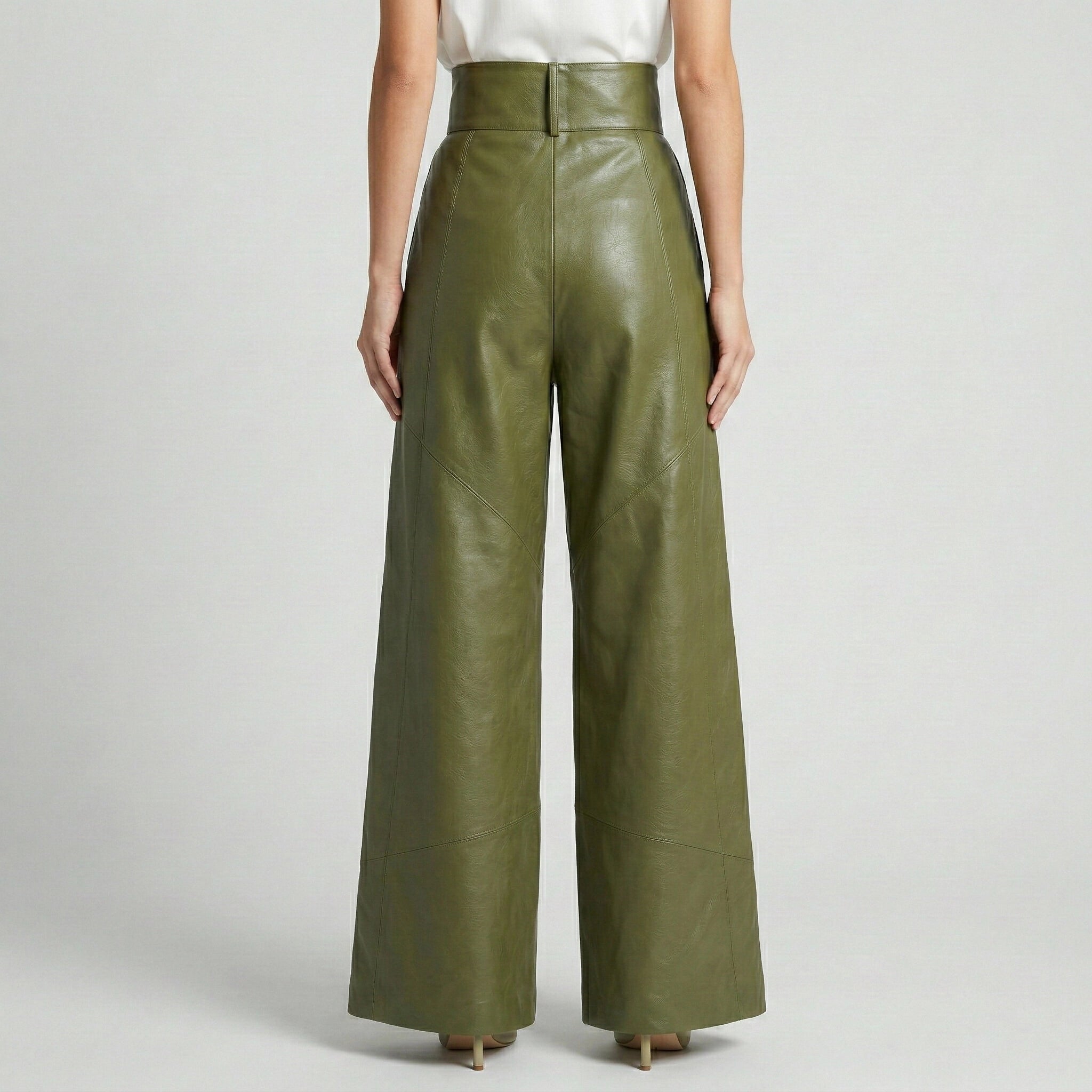 Green leather wide-leg pants worn by a person on a light gray background