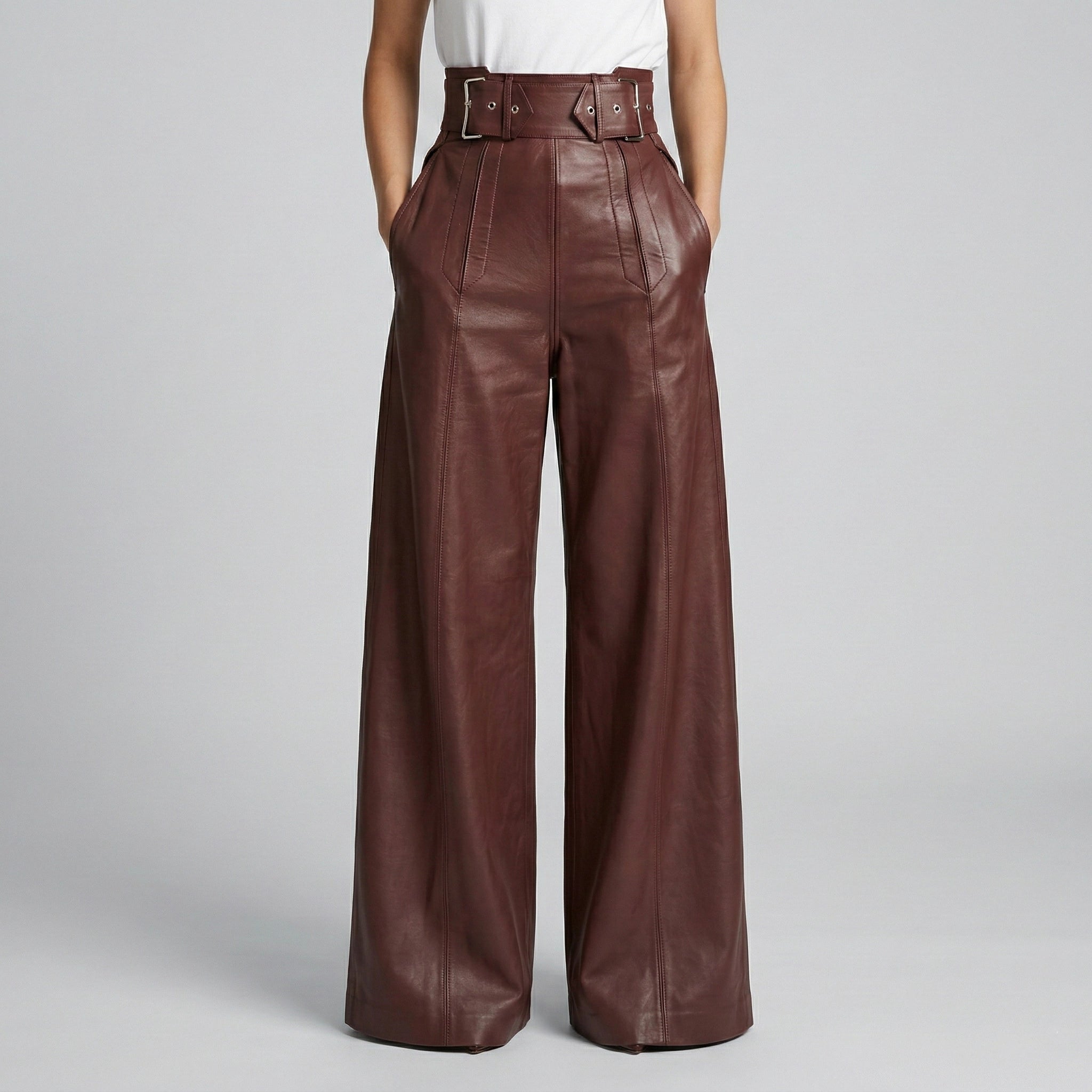 Brown leather wide-leg pants worn by a person on a light gray background