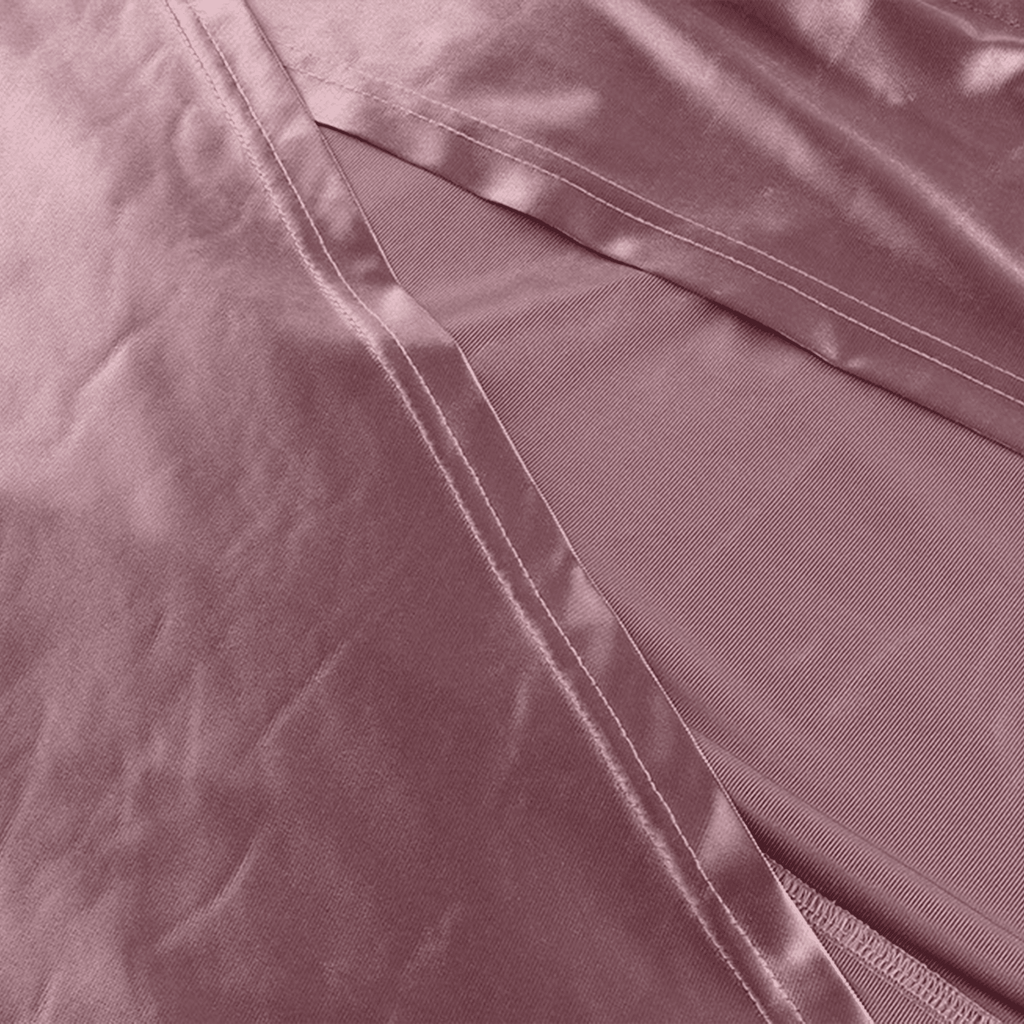 Close-up of a pink satin pillowcase with a subtle sheen.