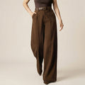 Brown wide-leg pants worn by a person on a beige background