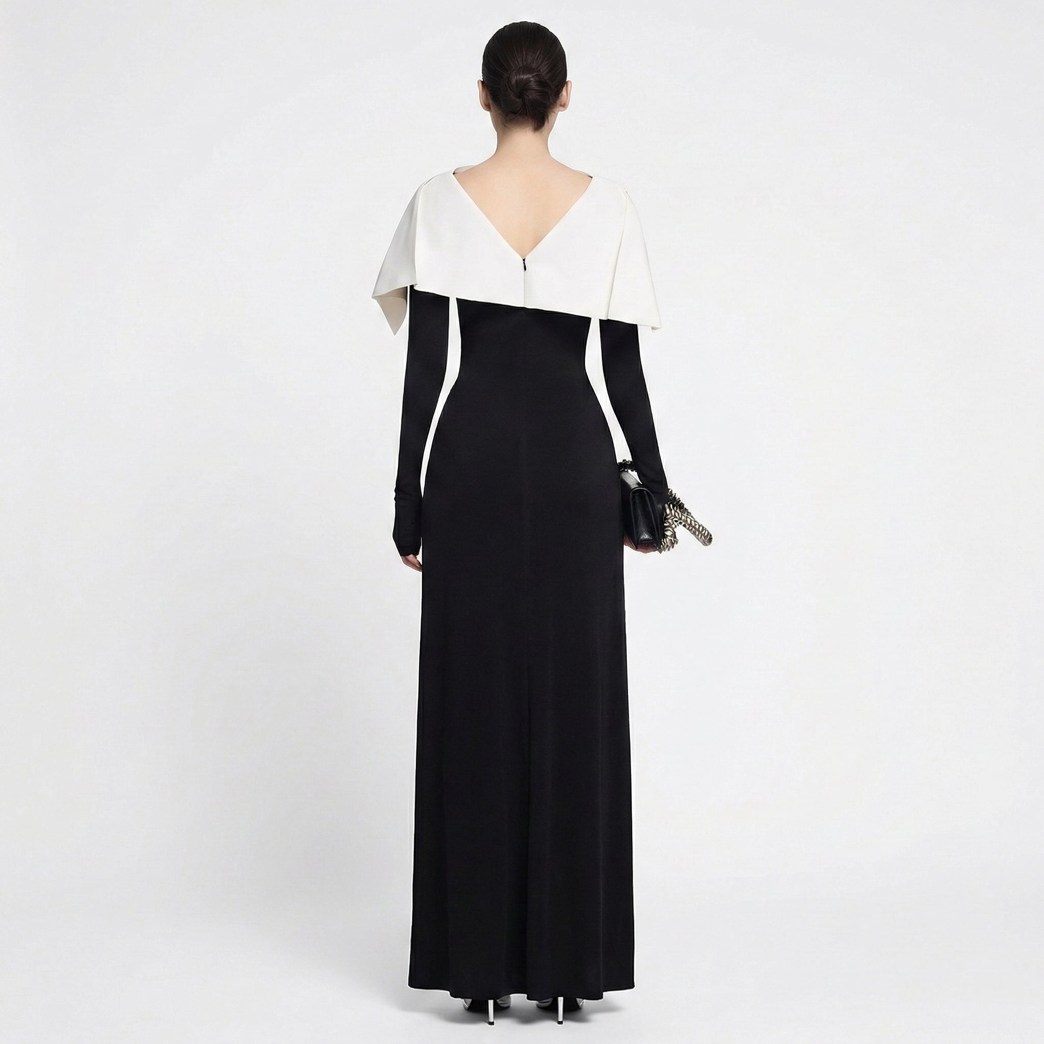 Woman wearing a black and white evening gown on a white background