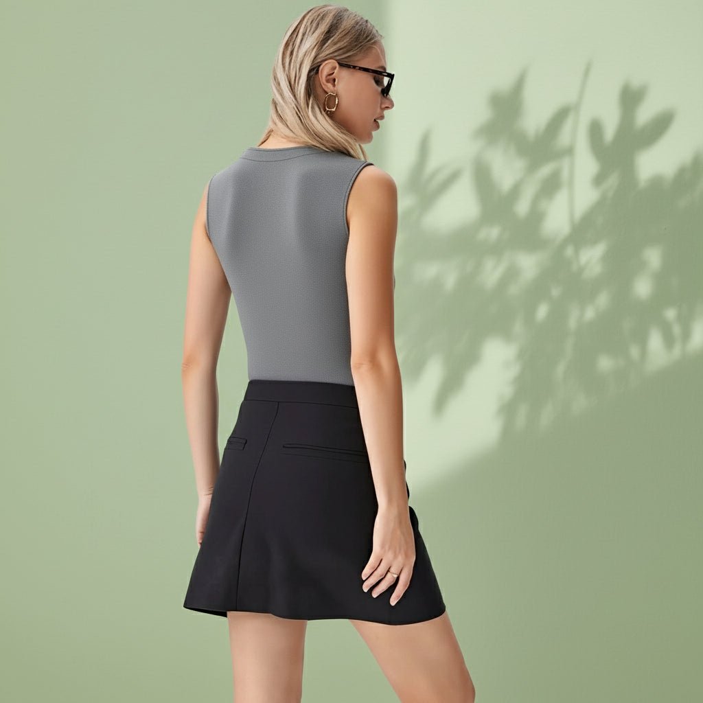 Woman wearing a gray top and black skirt on a white background