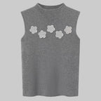 Gray sleeveless top with white floral patterns on a white background