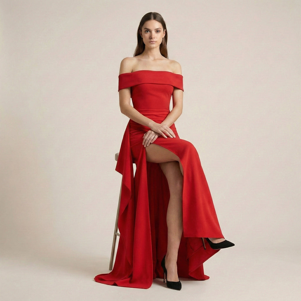 Woman wearing a red off-shoulder gown with a slit on a beige background
