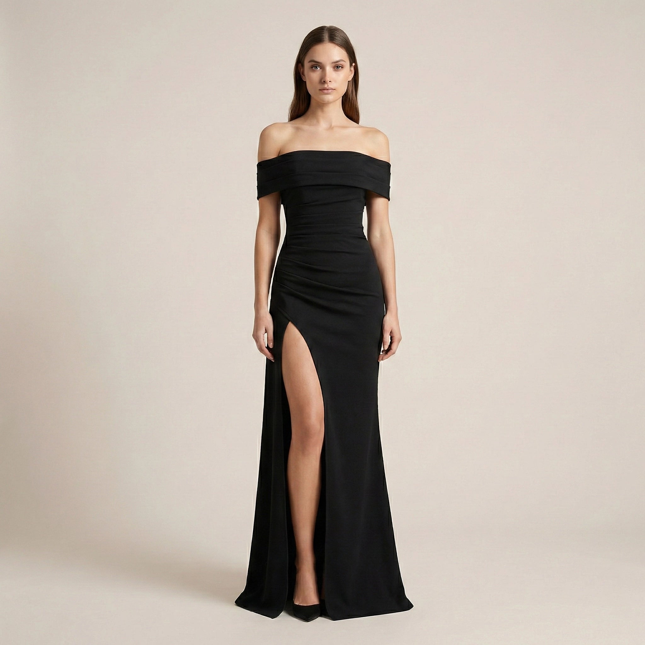 Black off-shoulder gown with a high slit on a beige background