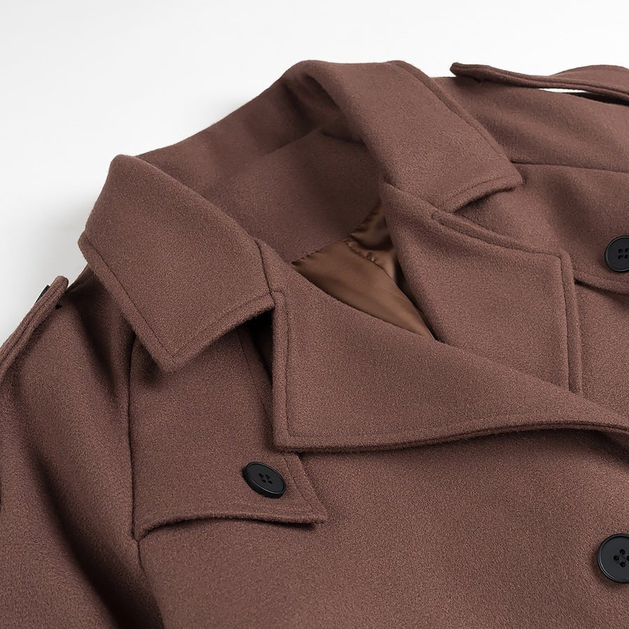 Close-up of a brown coat with buttons on a white background