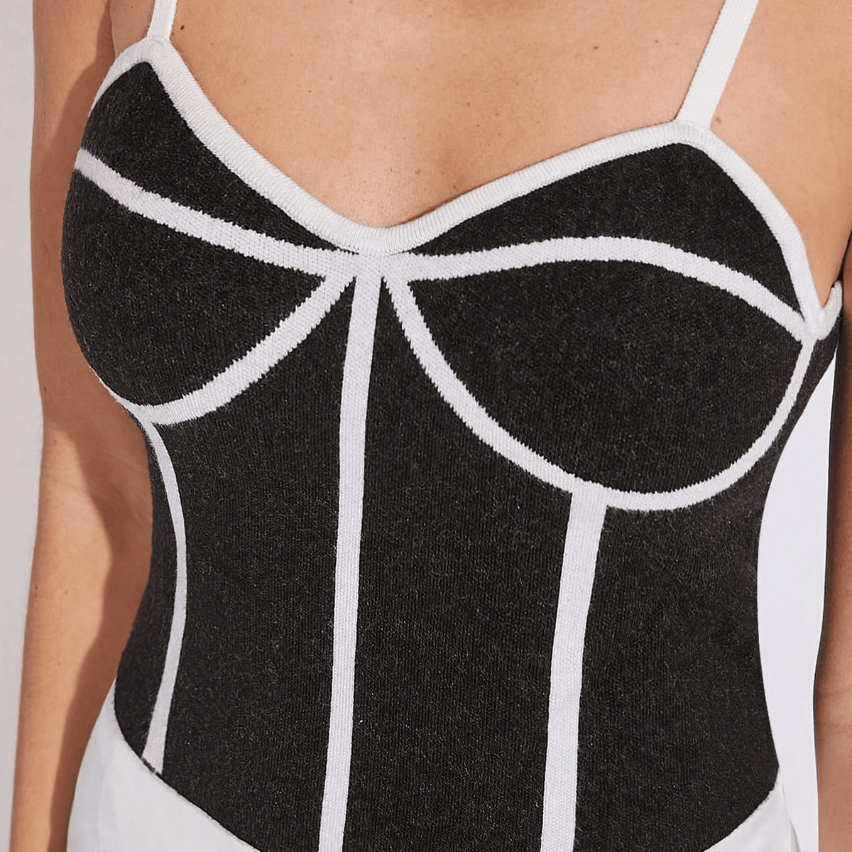 Black and white patterned swimsuit on a plain background
