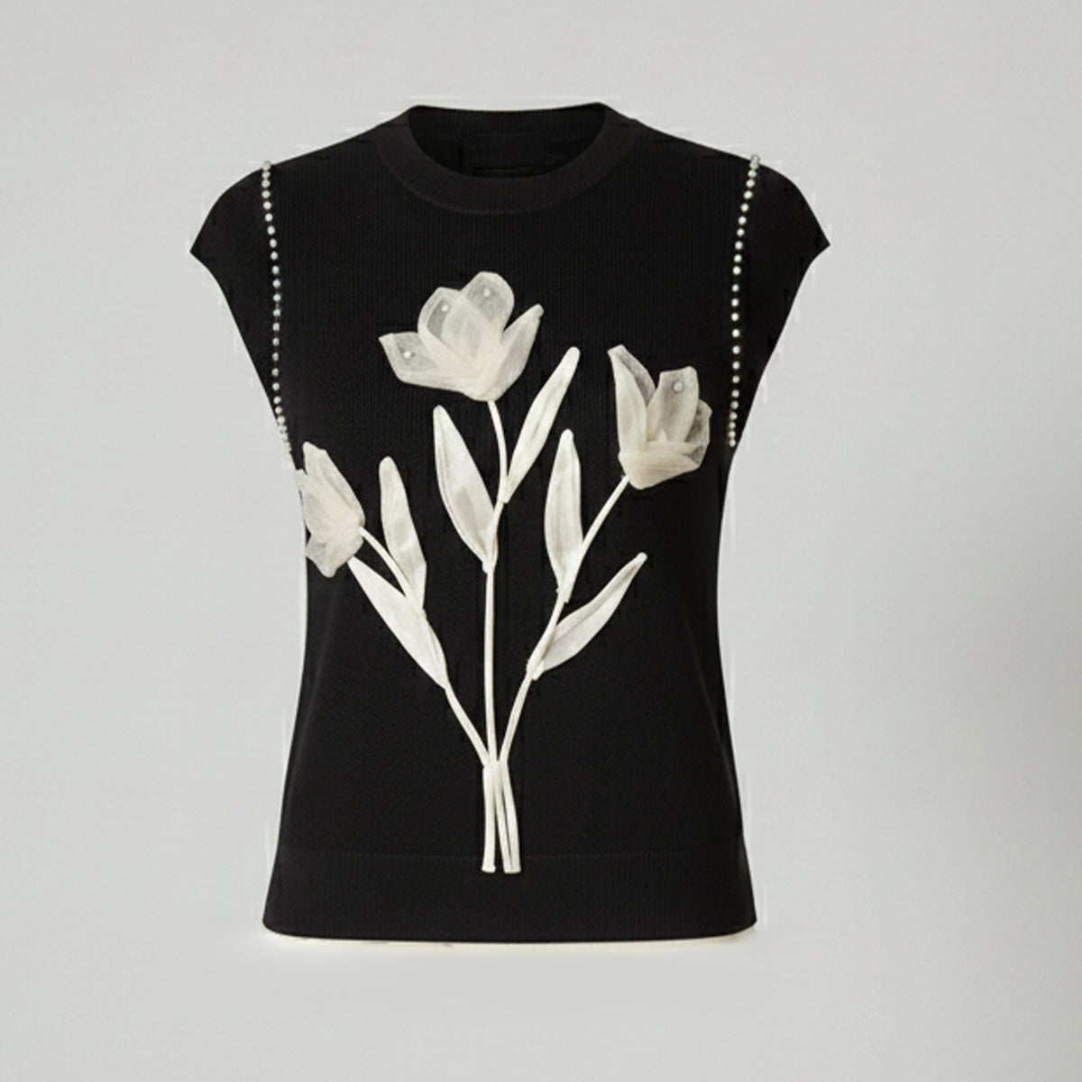 Black sleeveless top with white floral design on a light gray background