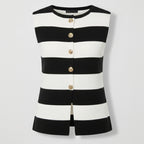 Black and white striped sleeveless top with gold buttons on a light gray background