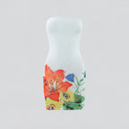 Floral-patterned bottle on a light gray background