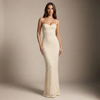 Woman wearing a white lace dress against a neutral background