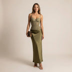 Woman wearing a green dress with a plain background