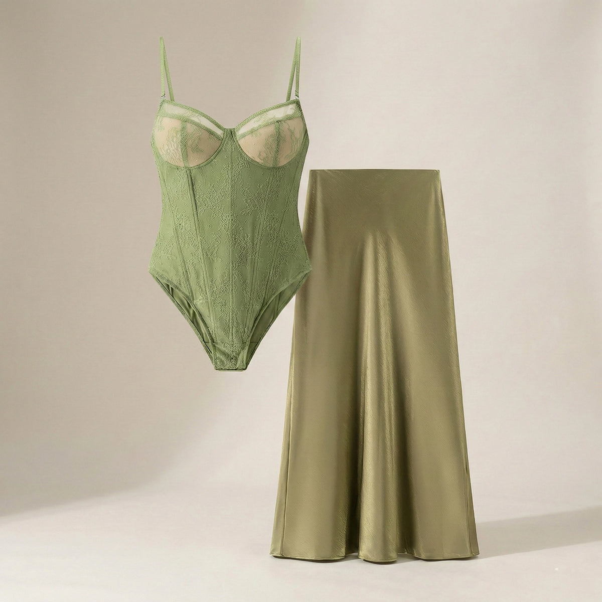 Green bodysuit and satin skirt on a neutral background