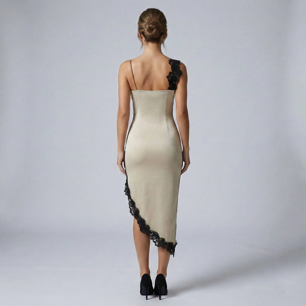 Woman wearing a beige evening gown with black lace details on a plain background