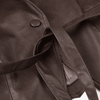 Close-up of a brown leather bag with a strap