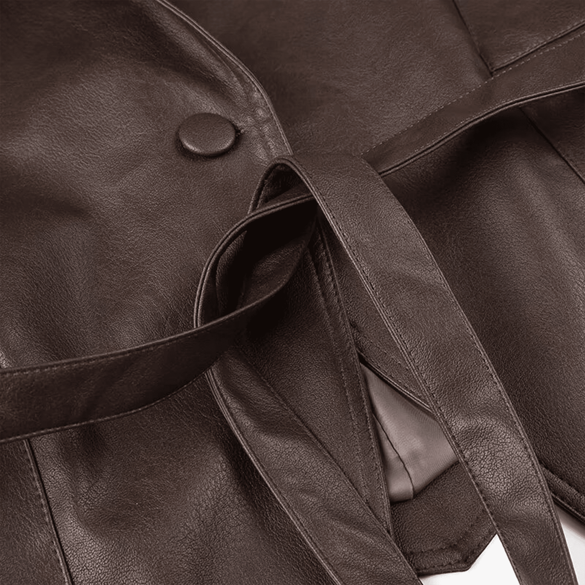 Close-up of a brown leather bag with a strap