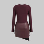 Maroon dress with leather skirt on a light gray background