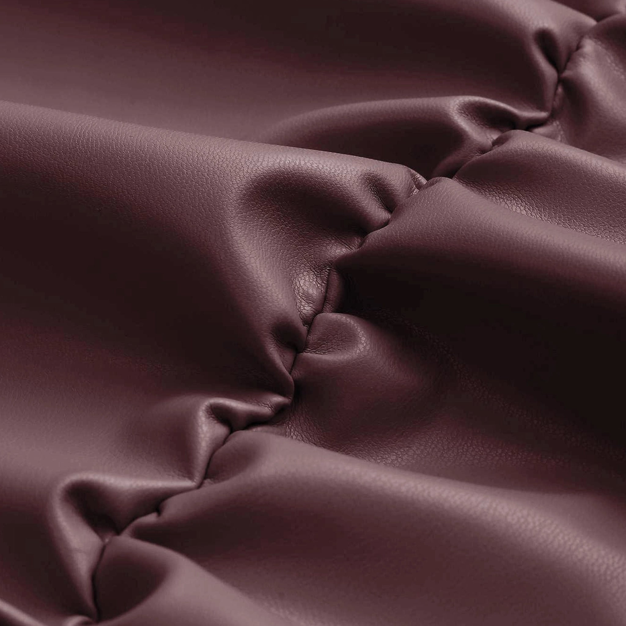 Close-up of maroon fabric with folds
