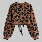 Leopard print sweater with a tie detail on a light gray background