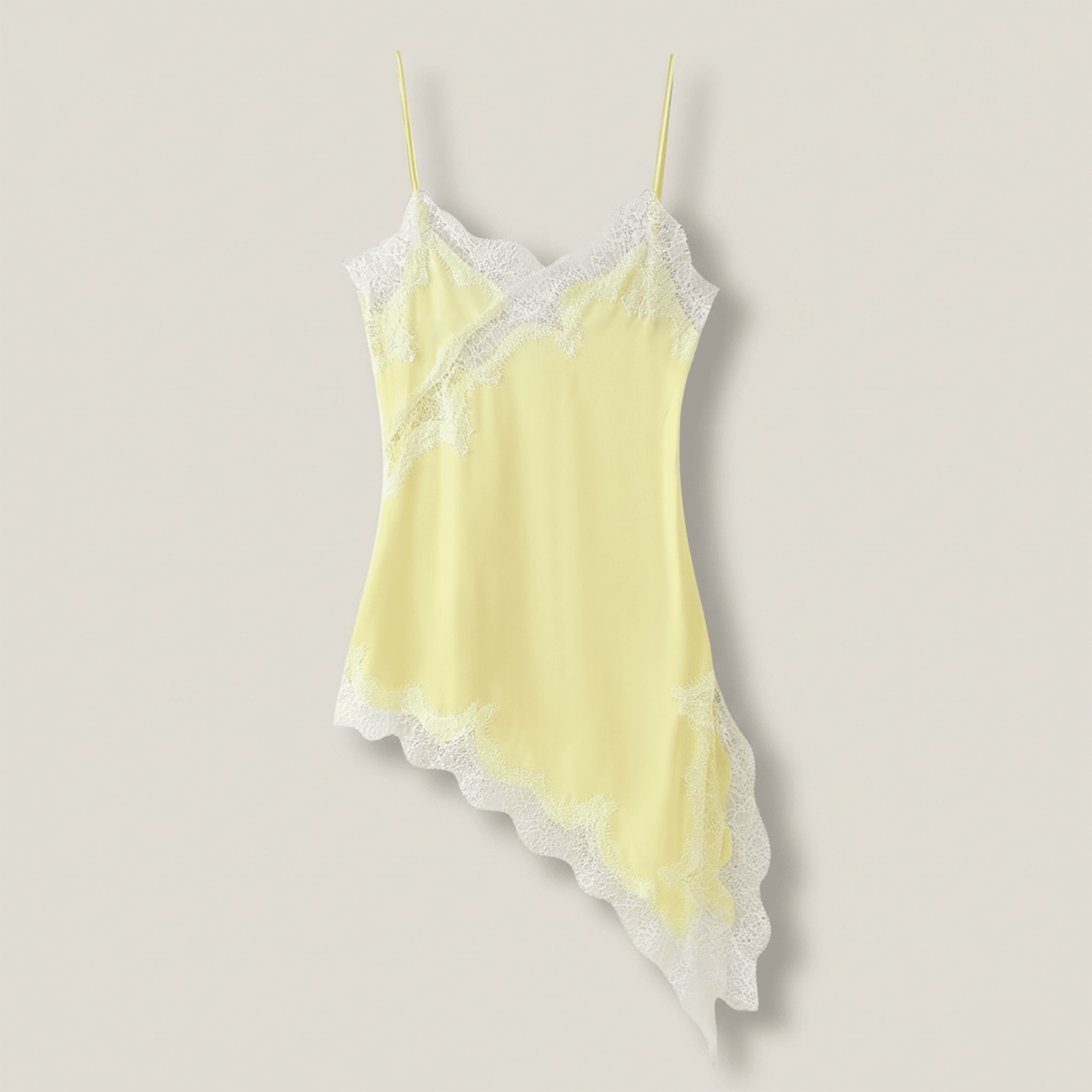 Yellow lace-trimmed camisole on a beige background
