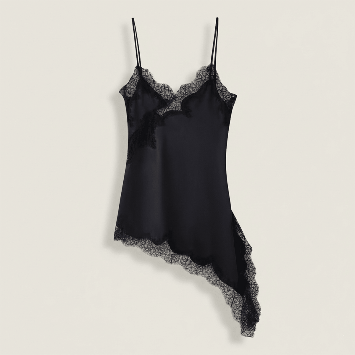 Black satin slip dress with lace trim on a light beige background