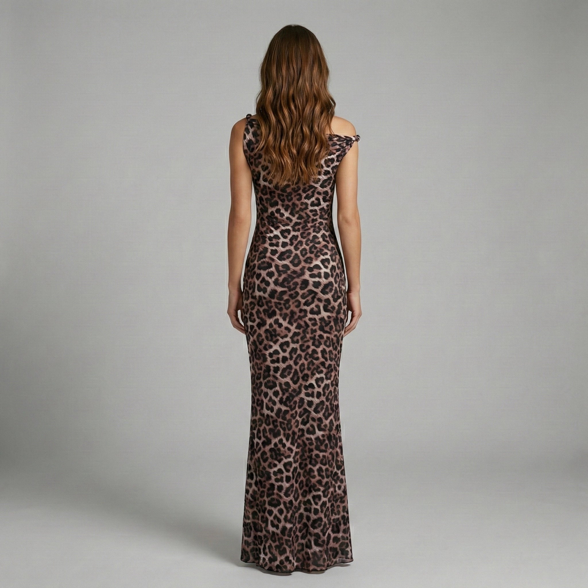 Woman wearing a leopard print dress against a gray background