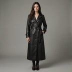 Woman wearing a black leather trench coat against a gray background