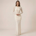 Woman wearing a white evening gown against a plain background