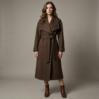 Woman wearing a brown coat against a plain background