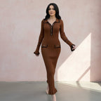 Woman wearing a brown outfit with a matching jacket and skirt on a gray background