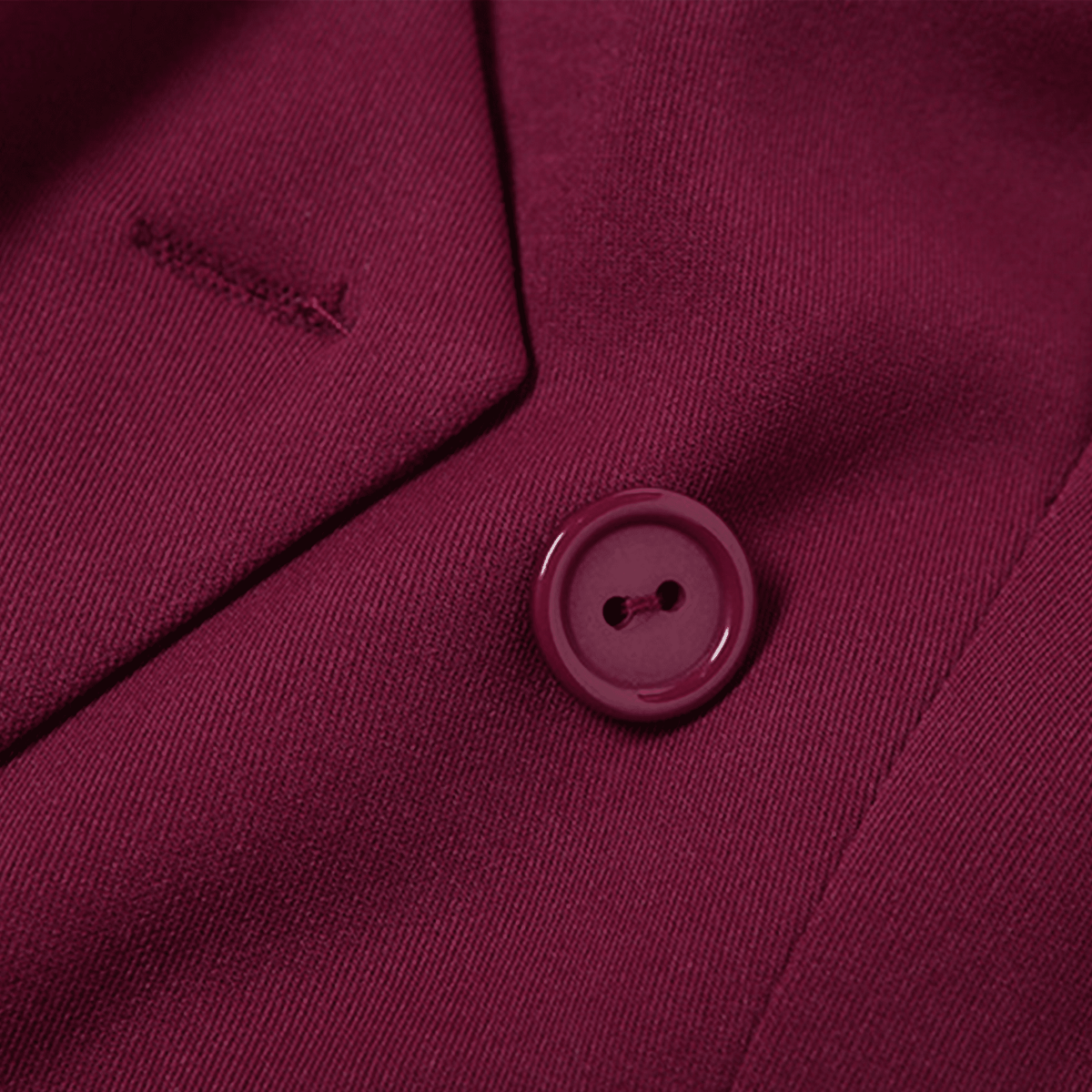 Close-up of a burgundy button on a garment with a brand logo.