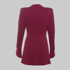 Back view of a maroon dress on a gray background