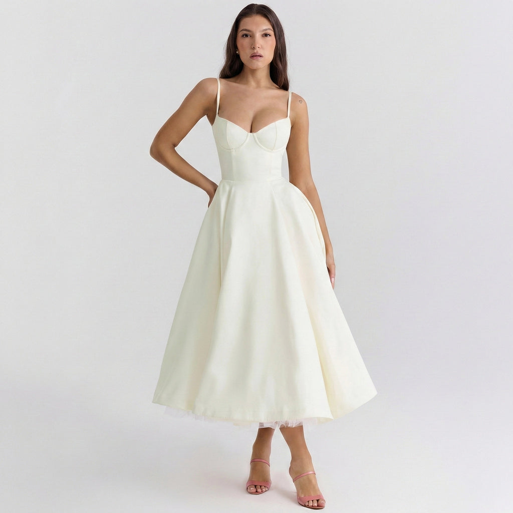 Woman wearing a white dress on a plain background