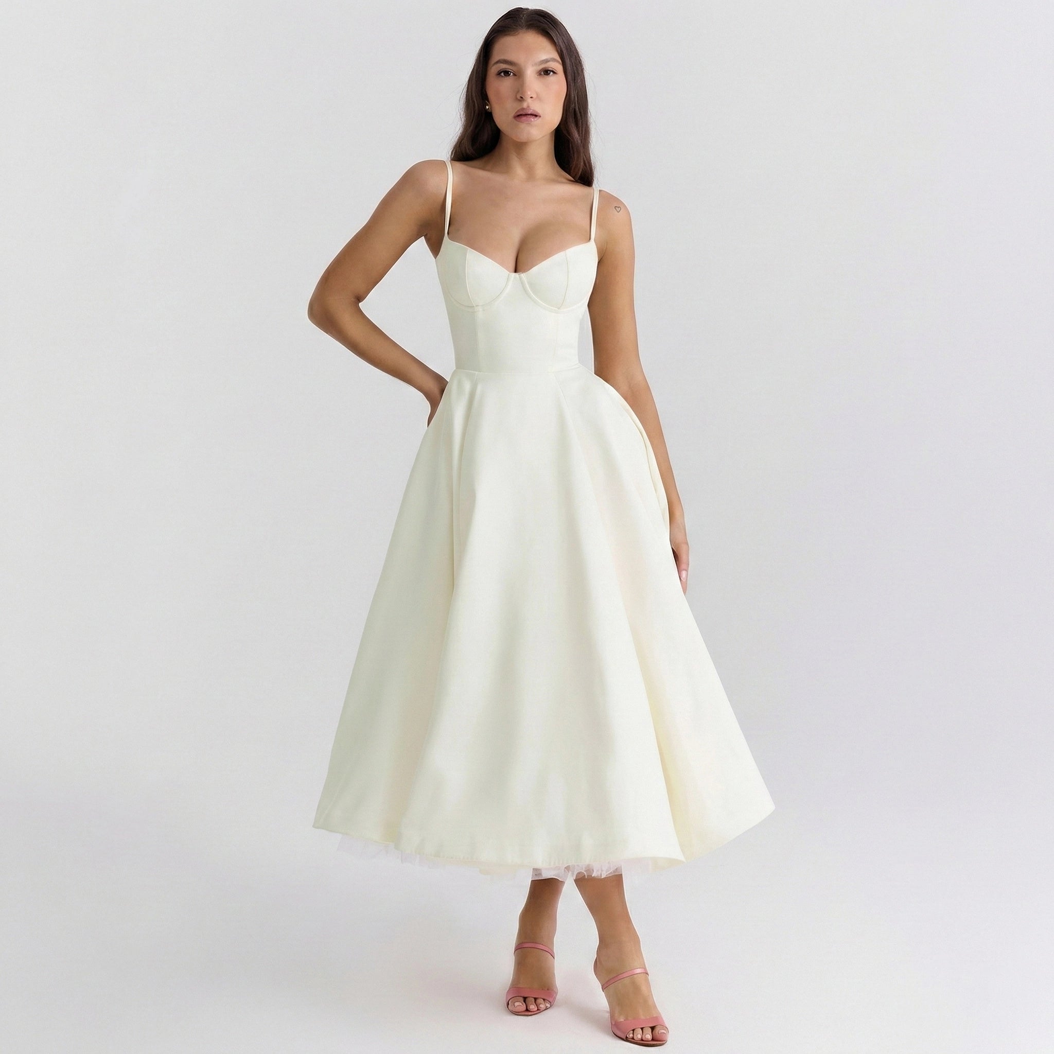 Woman wearing a white dress on a plain background