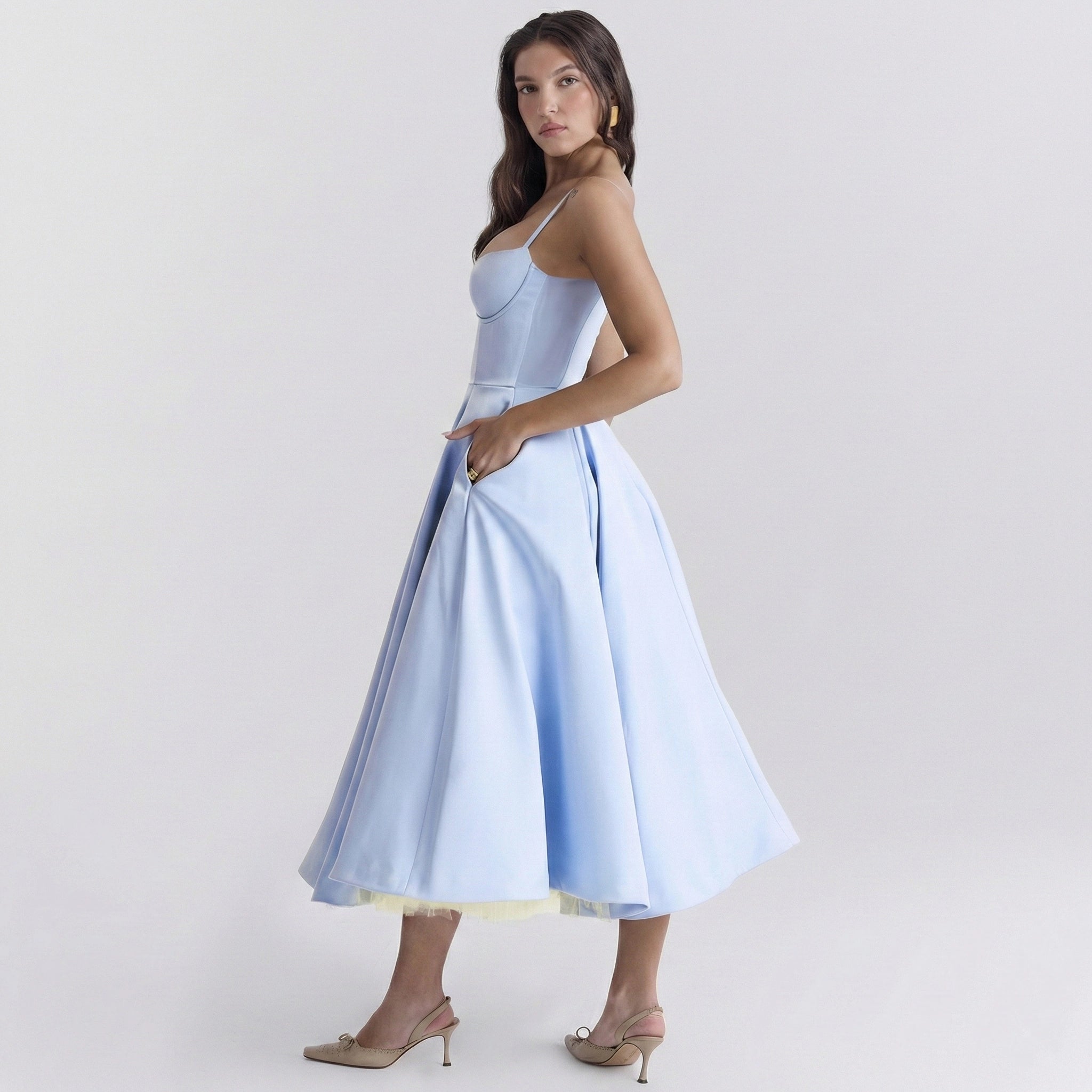 Woman wearing a light blue dress on a white background