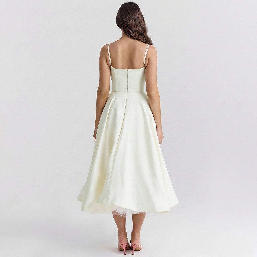 Woman wearing a white dress on a plain background