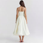 Woman wearing a white dress on a plain background