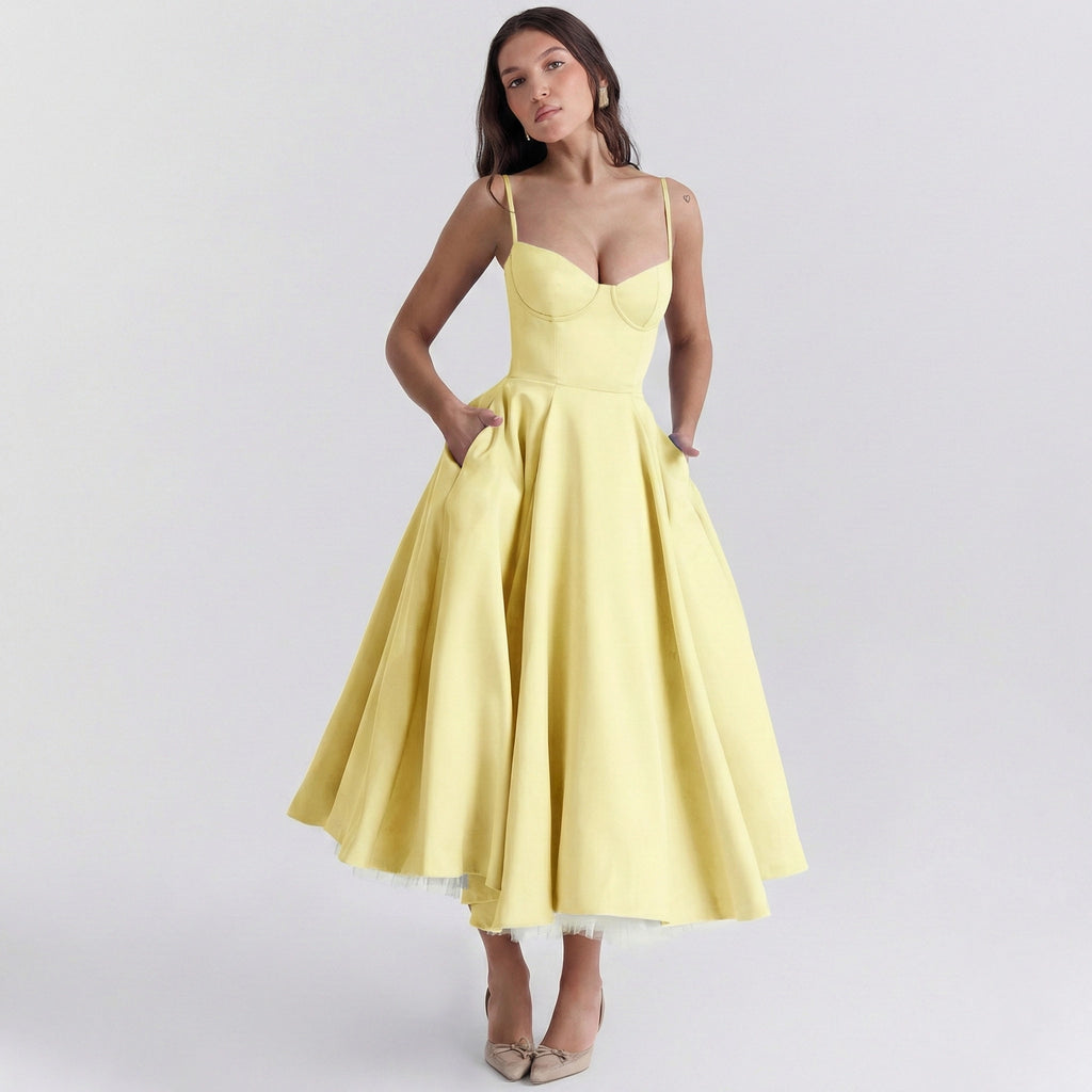 Woman wearing a yellow dress on a light gray background