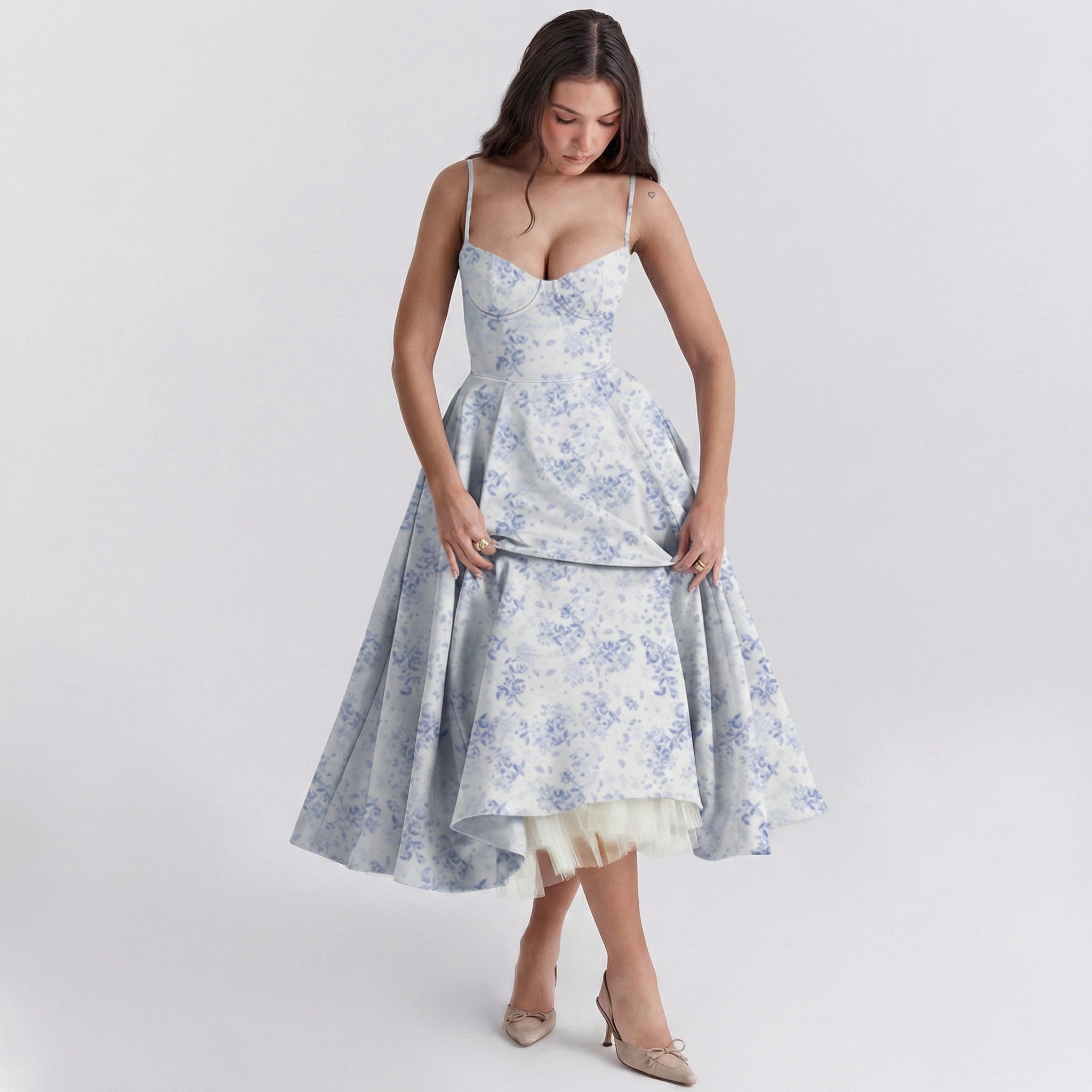 Woman wearing a floral dress on a plain background