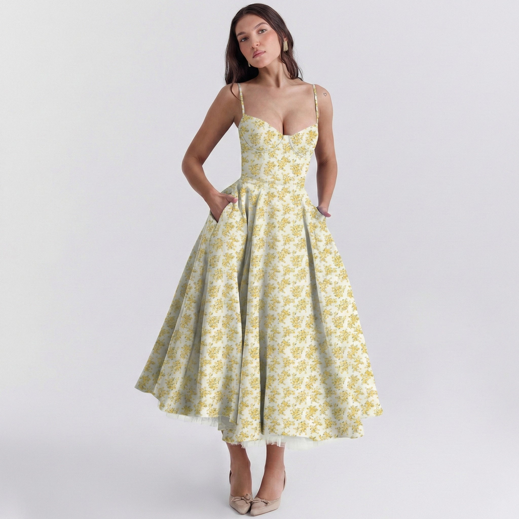 Woman wearing a yellow floral dress on a white background