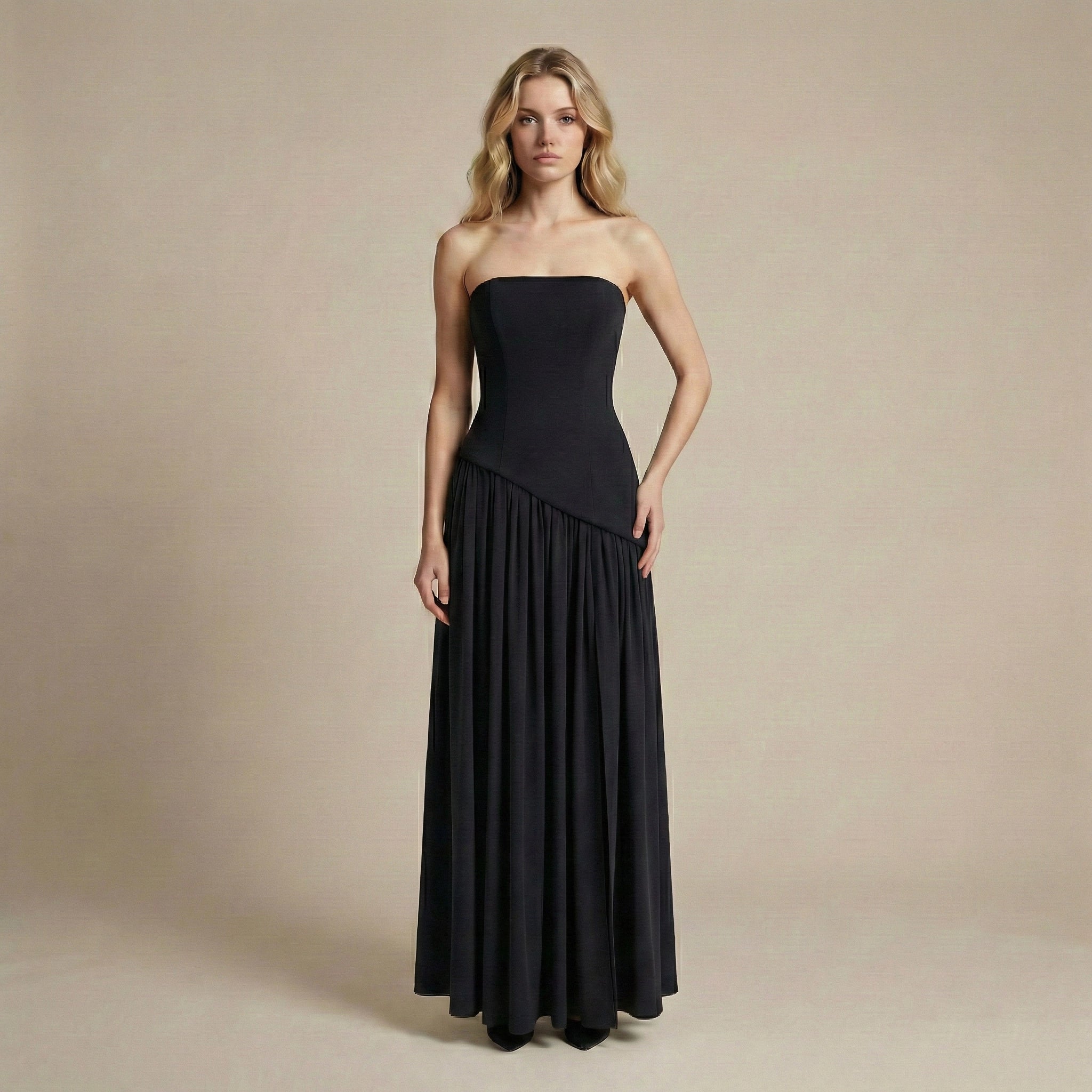 Woman wearing a black strapless gown against a beige background