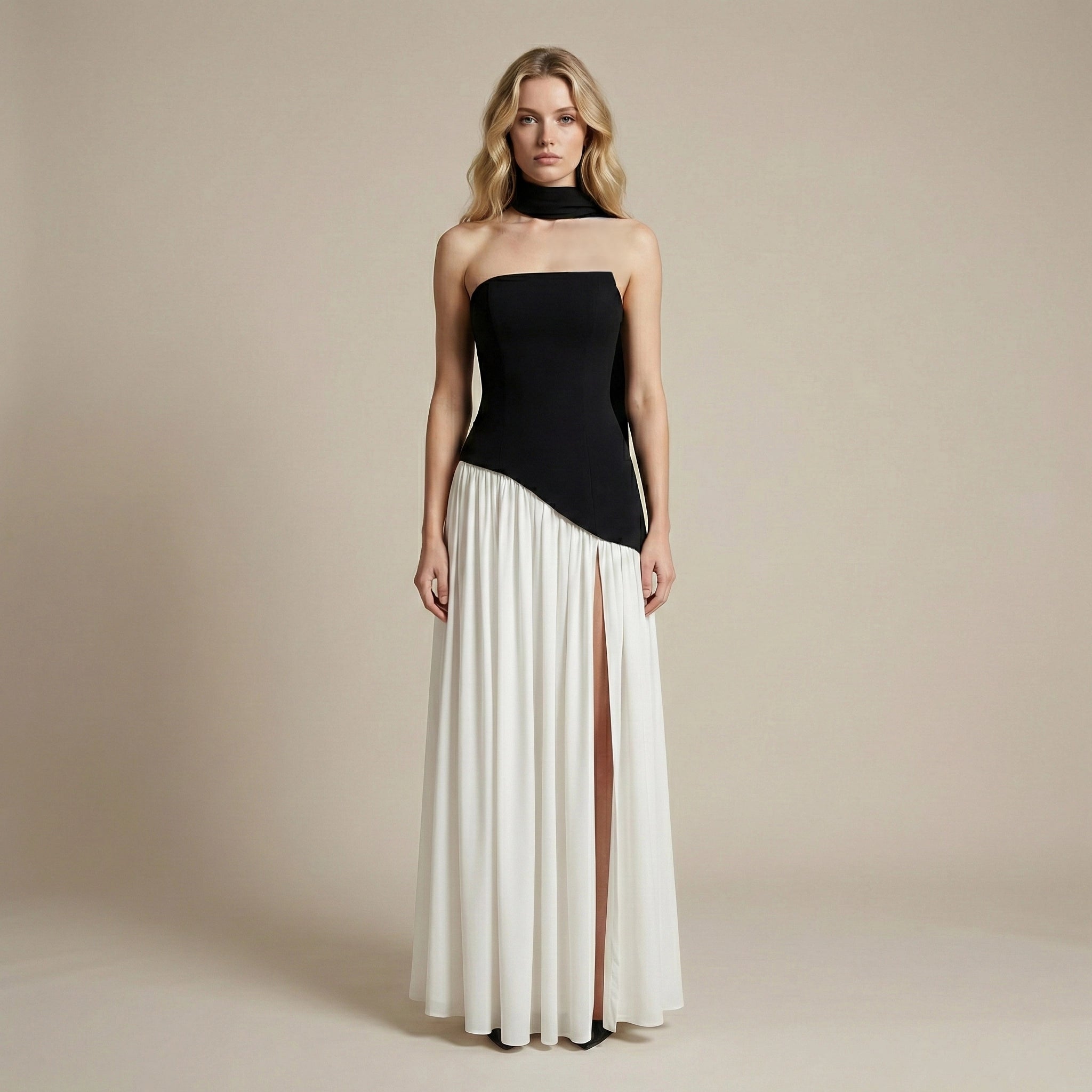 Woman wearing a black and white dress against a beige background