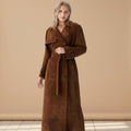 Woman wearing a brown trench coat on a white background