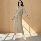 Woman wearing a beige dress with a wooden wall background