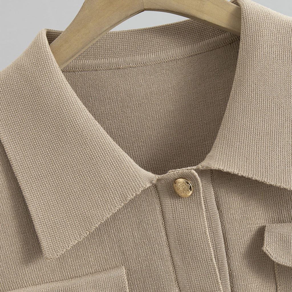 Close-up of a beige textured shirt with a button on a hanger