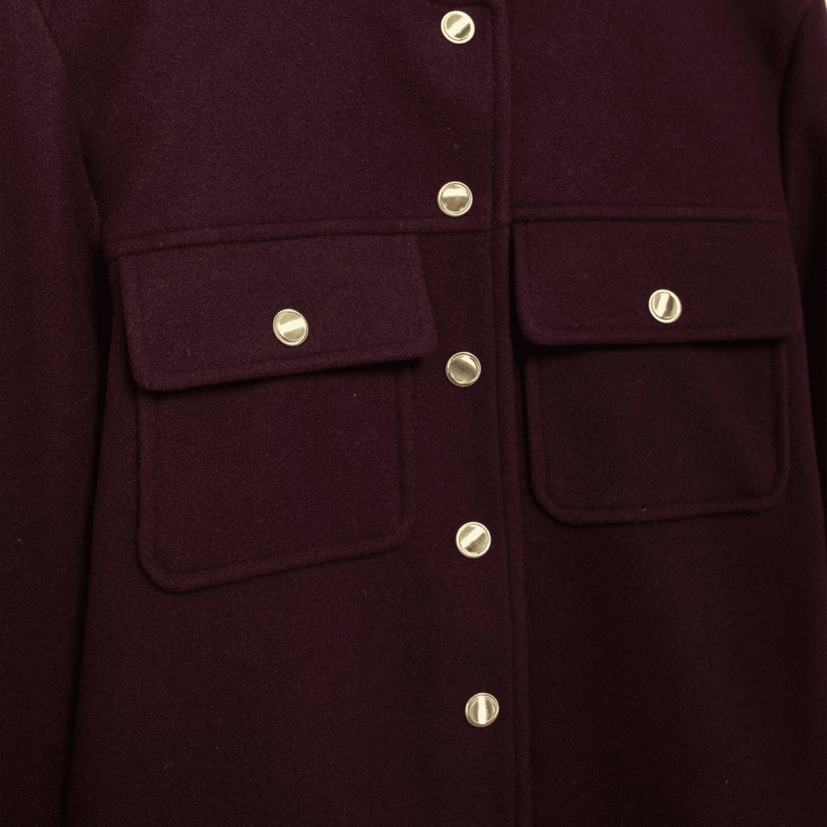 Close-up of a dark purple coat with gold buttons on a dark background